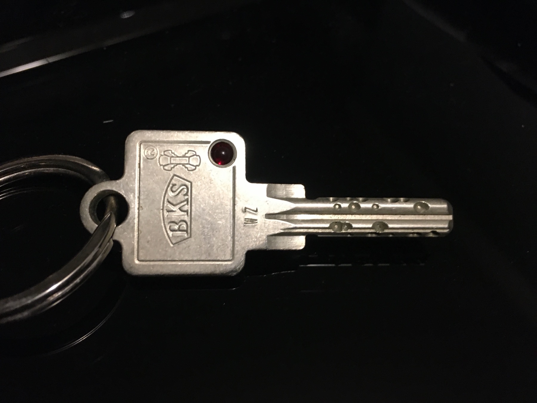 A secure door key on a black background